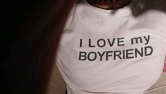 a woman wearing a t - shirt with the words i love my boyfriend printed on it