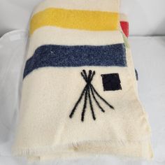 a white and blue striped blanket with black stitches on it