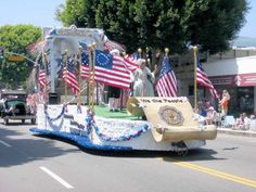 a parade float with flags and decorations on the street