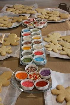 several trays of cookies and cupcakes on a table