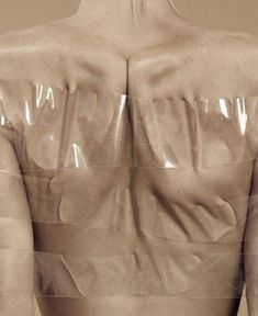 the back of a woman's torso with plastic covering it