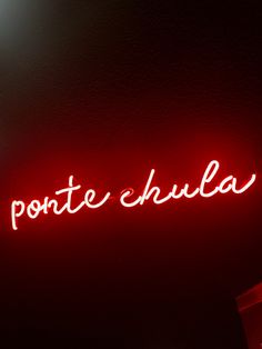 a red neon sign that says ponte shula on the side of a wall