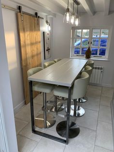 a dining room table with four chairs around it