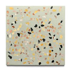 an abstract painting with gold, black and white colors on a light green background that resembles confetti