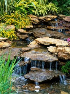 a small waterfall in the middle of a garden