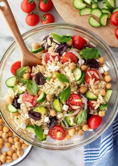 a glass bowl filled with rice, beans and veggies on top of a table