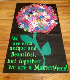 a black banner with colorful flowers and words on it that says we are each unique and beautiful but together we are a masterpiece