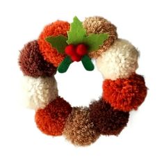 a knitted wreath with holly on top