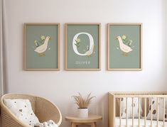 a baby's room with three framed pictures on the wall