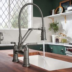 a kitchen sink and faucet with water running from it's spout