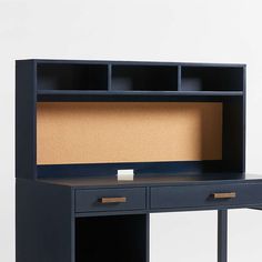 an office desk with a cork board on the top and two drawers below, against a white background