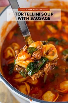 a spoon full of tortellini soup with sausage and spinach in it is being lifted from the pot