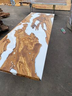 a table that is made out of wood and marbled with white paint on it