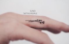 a person's hand with a small tattoo on it