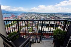 two black chairs sitting on top of a balcony