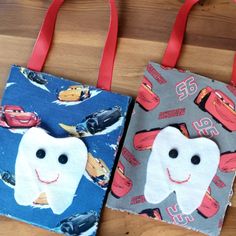 two tooth shaped bags sitting on top of a wooden table