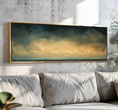 a painting hanging on the wall above a couch