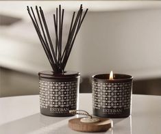 two candles sitting next to each other on a table