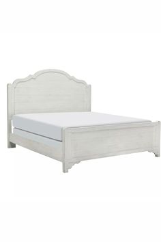 a white bed with a wooden headboard and foot board