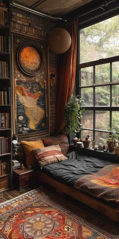 a bedroom with a large window, bookshelf and rugs on the floor