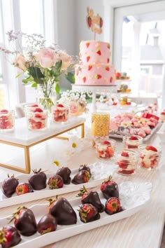 a table topped with lots of different types of desserts