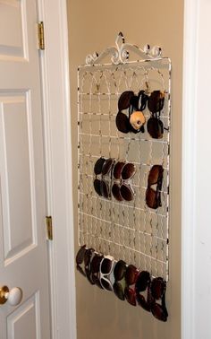 a rack with pairs of shoes hanging from it's sides next to a door