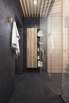 a bathroom with black walls and wood accents