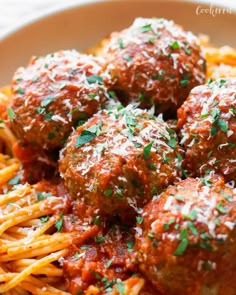 spaghetti and meatballs are served in a bowl