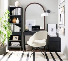 a white chair sitting in front of a desk with a mirror on top of it