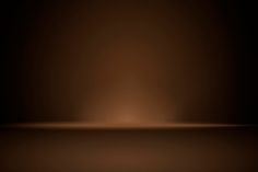 an image of a dark brown background that looks like it has light coming from the top