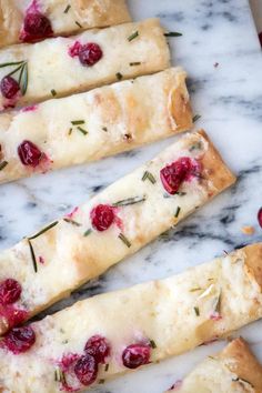 cranberry and rosemary flat bread sticks on a marble surface