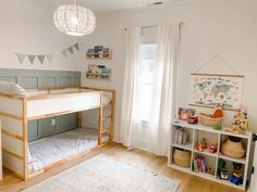 a child's bedroom with bunk beds and bookshelves in the corner next to a window