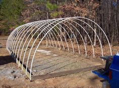 a large metal structure sitting in the middle of a forest