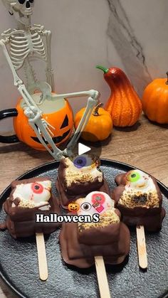 halloween treats are arranged on a black plate