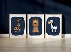 three framed pictures with animals and giraffes on them in a blue room