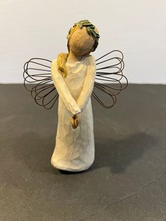 a ceramic figurine of a woman holding her hands behind her back