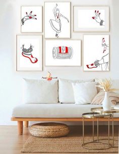 a living room filled with white furniture and pictures on the wall above it's coffee table