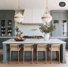 a kitchen with blue cabinets and white counter tops