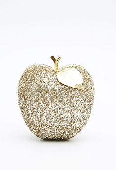 an apple made out of gold glitter on a white background