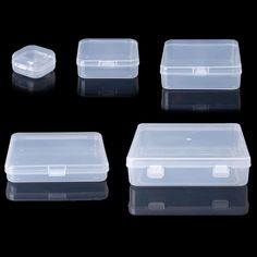 four plastic containers with lids on black background