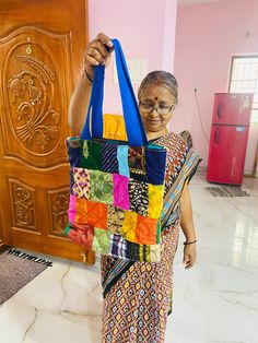 Ever wanted a bag that can carry almost everything that you can carry- this is one such bag. Made completely from tiny pieces of fabric thrown away by tailors, this patchwork tote bag is a perfect mix of style and utility.  It is a 13" x 14" with a 3" base as well. Has a pocket on the inside for you to quickly take out something you might need. The handle is made out of woven cotton. The inside lining is pure cotton. Completely washable, can handle weight upto 4 kgs. Please wash in cold water as it is good for the environment too.  Please note: The images are just a representation of the bag- every bag you see is unique. You can choose the colour of the handle. Rest is a mix of different colours and material. The colours of the patches you receive might not match the patchwork shown in the Colorful Patchwork Shoulder Bag For Daily Use, Multicolor Patchwork Bags For Shopping, Colorful Patchwork Shoulder Bag For Everyday Use, Colorful Patchwork Bags For Daily Use, Colorful Patchwork Bags For Everyday Use, Travel Tote Bag With Patchwork, Cotton Patchwork Tote Bag, Multicolor Patchwork Tote Bag, Colorful Patchwork Rectangular Bag