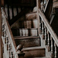 an old set of stairs with wooden handrails