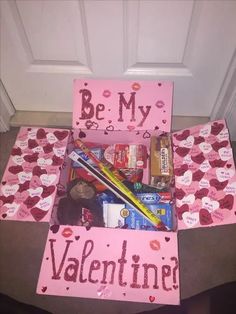 a valentine's day box with candy, chocolates and other items in it