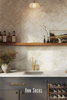 an image of a kitchen setting with bottles on the counter and wine glasses on the shelf