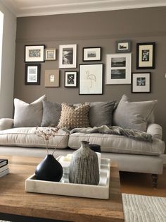 a living room filled with lots of furniture and pictures on the wall above it's coffee table