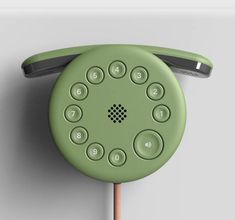 an old fashioned green phone is hanging on the wall