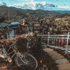 a bicycle is parked on the side of a hill