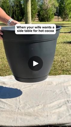 a woman is holding a large bucket with a sign on it that says, when your wife wants a side table for those coolers