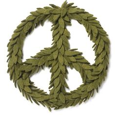 a peace sign made out of green leaves