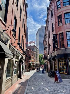 people are walking down the street in front of some buildings